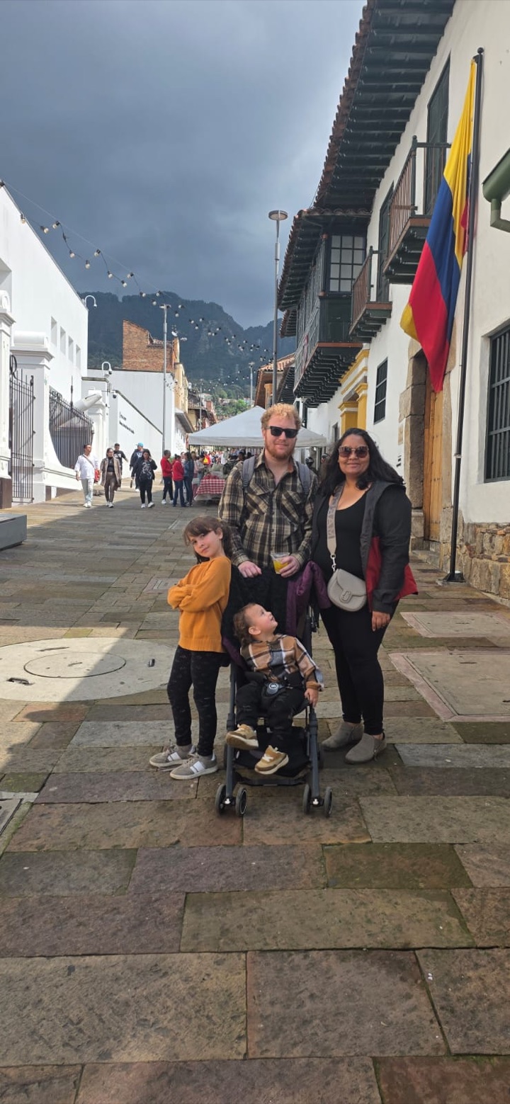 Steven with his partner and two children on a cobbled street in Colombia